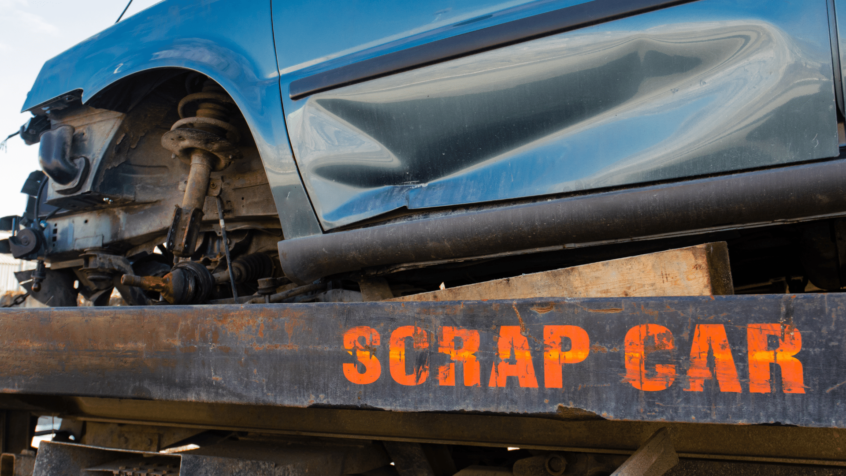 visual image of scrap car on rig